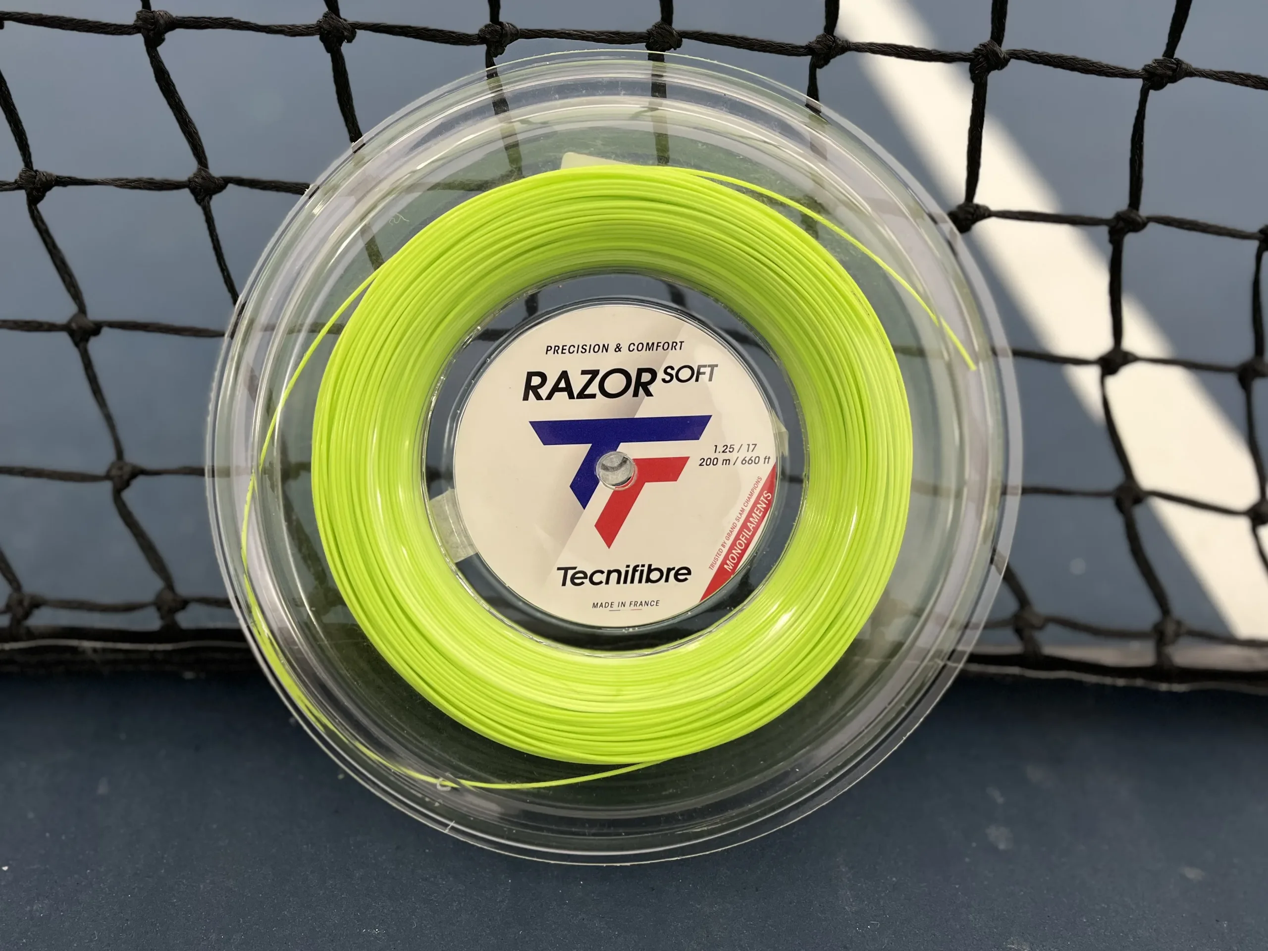 Tecnifibre Razor Soft Lime reel on a tennis court